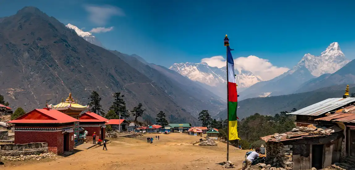 Tengboche village in Khumjung, Khumbu Region, Nepal, with traditional buildings, prayer flags, and a backdrop of the Himalayas.